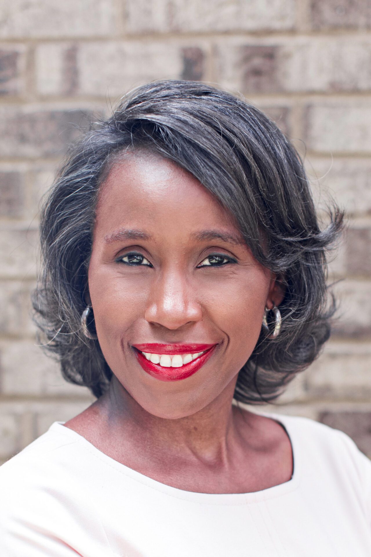 A woman with red lipstick and black hair.